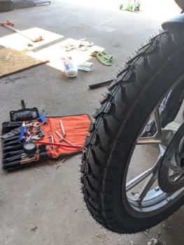 Image of new tire and custom roadside tool kit